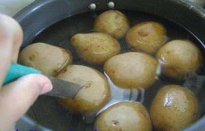 Poke knife in one of the potato