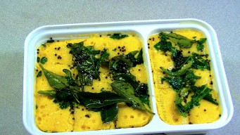 Dhokla made in microwave with tadka is ready to serve Dhokla made in microwave with tadka is ready to serve